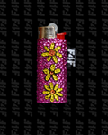 Pink lighter with yellow floral designs on a black background